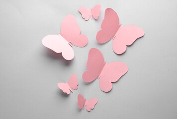 Obraz premium Butterflies cut out of paper on a gray background. Spring background