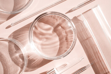 Fototapeta na wymiar serum in petri dishes on light beige background cosmetic research concept