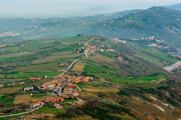 Fototapeta na wymiar Top view of the hilly green landscape of San Marino from the Falesia Second tower