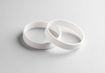 White silicone bracelets on gray background. Template for design