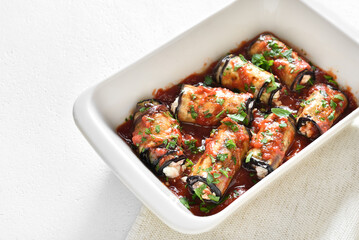 Baked eggplant rolls with tomato sauce and cheese