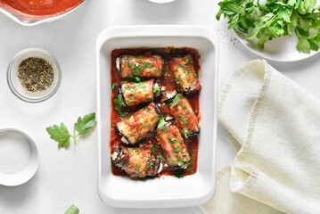 Baked eggplant rolls with tomato sauce and cheese