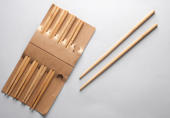 Set of wooden chinese chopsticks on a gray background