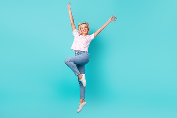 Fototapeta na wymiar Full size photo of cheerful satisfied woman wavy hairdo striped t-shirt raising hands up flying isolated on bright teal color background