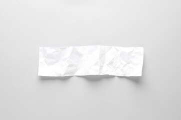 Crumpled paper banner on gray background