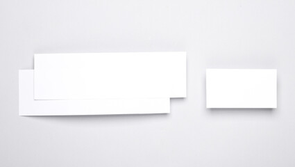 Mockup of two white blank tickets or flyers and business card on gray background. Template for design