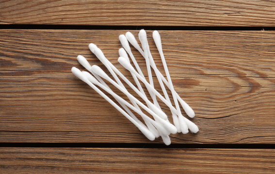 Hygiene ear cotton swabs for cleaning ears on a wooden background. Top view
