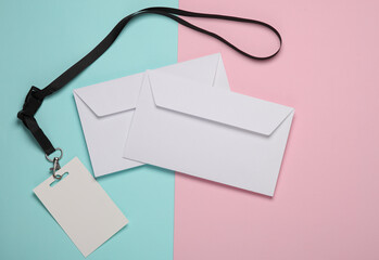 Empty white ID card badge and envelopes on pink blue background. Template for design