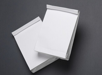 White paper lunch bags mockup on dark gray background