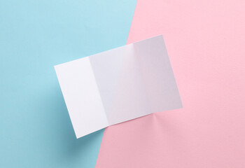 Obraz na płótnie Canvas White paper brochure mockup on pink blue pastel background. Top view
