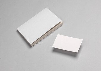 Book mockup with white cover and business cards on gray background