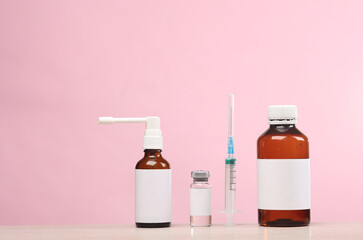 Medicines with blank labels on a pink background. Template for design