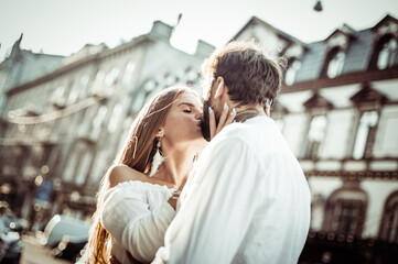 Young couple in love is kissing in the city. Love and romantic concept