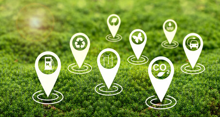 Environmental and sustainability concept - icons on sustainability such as wind energy, solar energy, recycling, climate neutrality, nature on green moss.