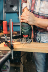 Carpenter cutting wood with jigsaw