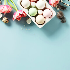 Easter background with spring flowers, eggs and feathers on light blue background top view flat lay copy space
