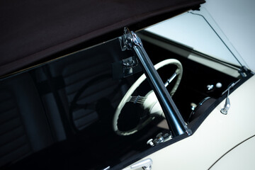 Obraz premium View of a windshield and steering wheel of a vintage car