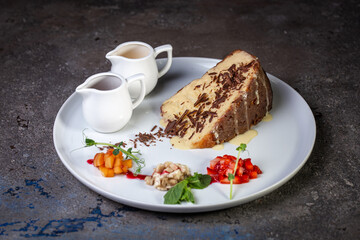 dessert soaked sponge cake with berries on a white plate
