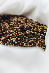 A peppercorn mix on a white material 