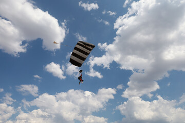 Summer sky. A parachute is in the cloudy sky.