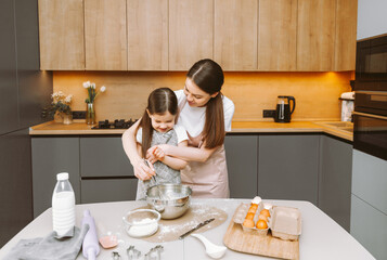 happy family in the kitchen. mother and daughter prepare dough, bake cookies, Easter cake.