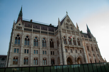 Fototapeta premium A low angle of the Hungarian Parliament building at back lit by the sun in the summer in the city of Budapest