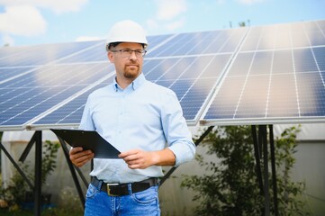 Engineer at solar power station with solar panel. Practical lessons on renewable energy power plants.