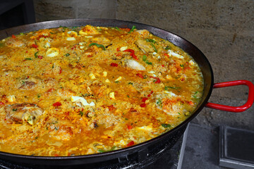 Close up cooking Spanish paella in big frying pan