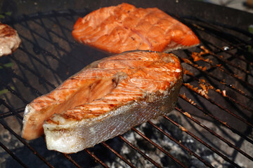 Cooking salmon fish steak on BBQ grill