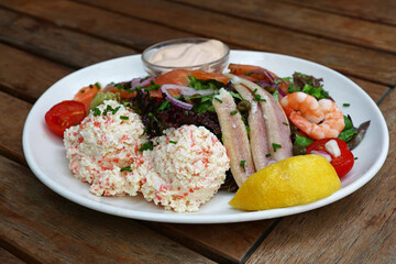 Cold and smoked seafood platter on wooden table