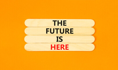 The future is here symbol. Concept words The future is here on wooden stick. Beautiful orange table orange background. Motivational business the future is here concept. Copy space.