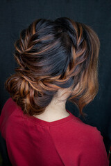 Naklejka premium Photo of a stylish female hairstyle, on the back of the girl's head. Image for your creative decoration or design.