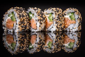 Assorted sushi rolls with salmon tuna cucumber and sesame seeds on dark background © Lemonade