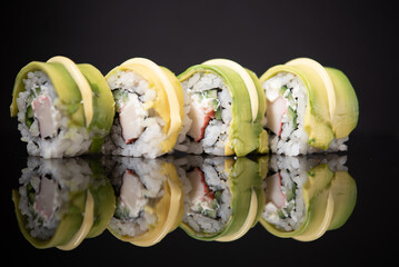 Assorted sushi rolls with salmon tuna cucumber and sesame seeds on dark background © Lemonade