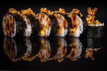 Assorted sushi rolls with salmon tuna cucumber and sesame seeds on dark background © Lemonade