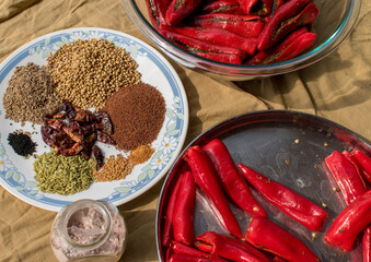 Preparing homemade stuffed red chilli pickle or laal mirchi ka Achar or Loncha. 
