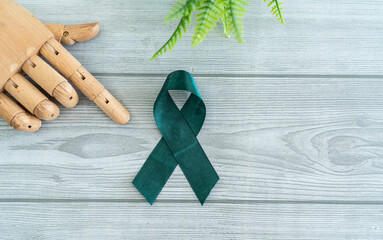 National Aplastic Anemia and MDS
Awareness Week, green awareness ribbon with wooden hand 