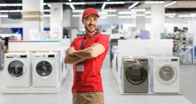Sales manager posing inside an electrical appliance shop with washing machine