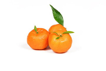 Three ripe orange tangerines on a white background