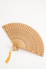 Wooden Hand Fan with cutout design and tan tassel