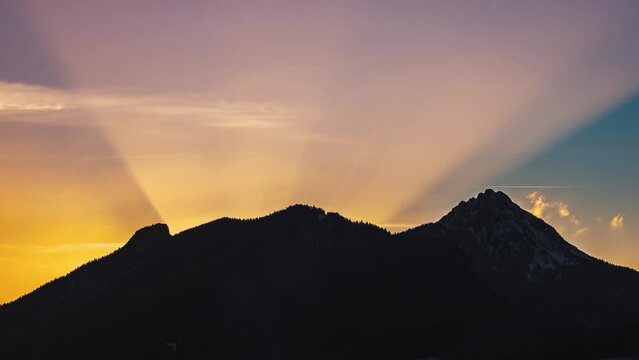 Last light of sunset behind alps mountains in beautiful evening nature Time apse background