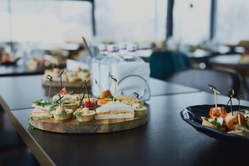 Dessert assortment of tartlets with shrimp and sandwiches on a plate