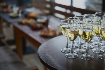 Beautiful glass glasses with fragrant wine on the background of snacks.
