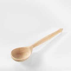 Wood kitchen utensils. Wooden spoon on a white mirror background