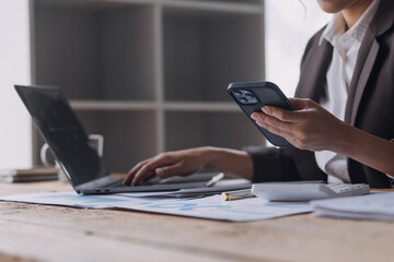 Businesswoman or accountant working Financial investment on calculator, calculate, analyze business and marketing growth on financial document data graph, Accounting, Economic, commercial concept.