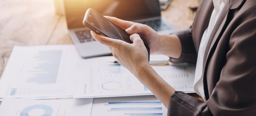 Obraz premium Businesswoman or accountant working Financial investment on calculator, calculate, analyze business and marketing growth on financial document data graph, Accounting, Economic, commercial concept.