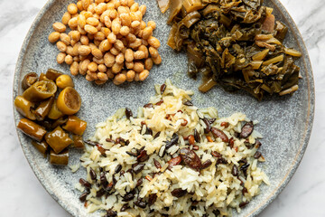 Stir fried rice with pepitas and sunflower seeds, Asian type pickled chilies, pickled mustard greens and homemade natto. Healthy vegan food.