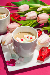 Valentine's Day romantic concept. Coffee with marshmallows, tulips flowers, traditional design