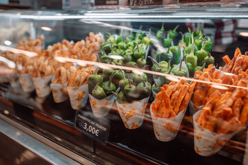 Fried potatoes, green pepper appetizer at La Boqueria market in Barcelona, ​​Spain. 