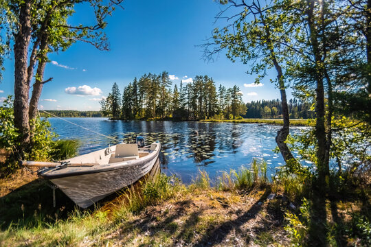 Summer day at a lake with a boat in Sweden